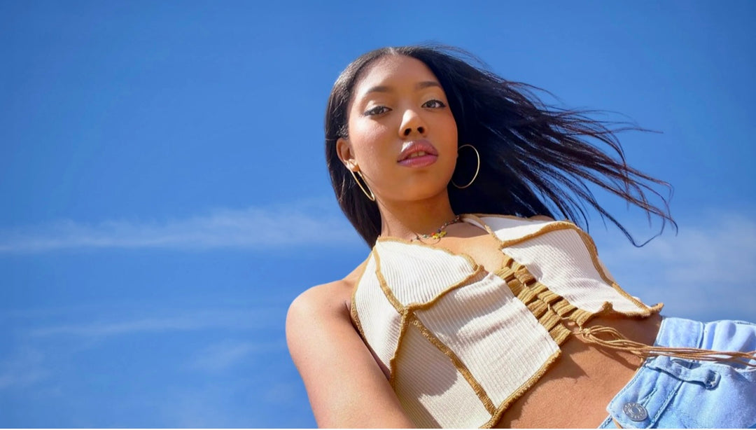 beautiful black asian girl against a spacious blue sky background